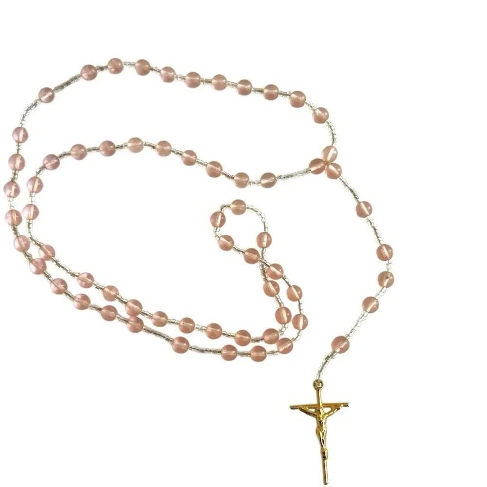 Pink glass rosary with gold tone cross